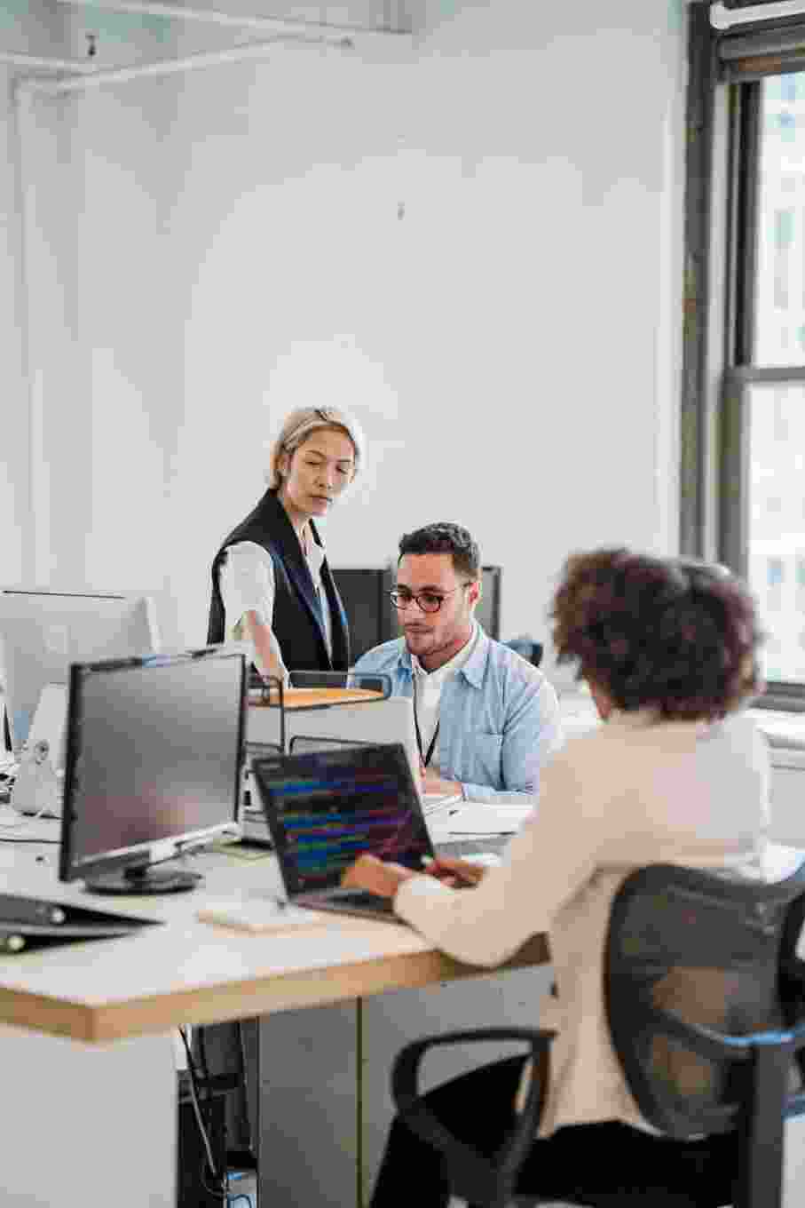 Business team working collaboratively with computers